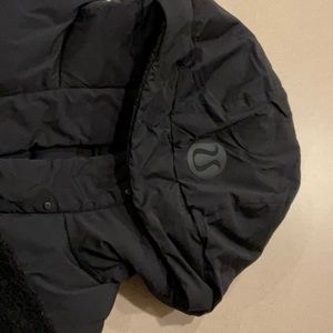 Lululemon black pullover down puffer with fuzzy sleeves.